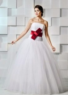 Magnificent wedding dress with a red bow