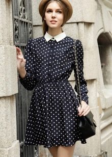 Black dress with a polka dot print and a white collar