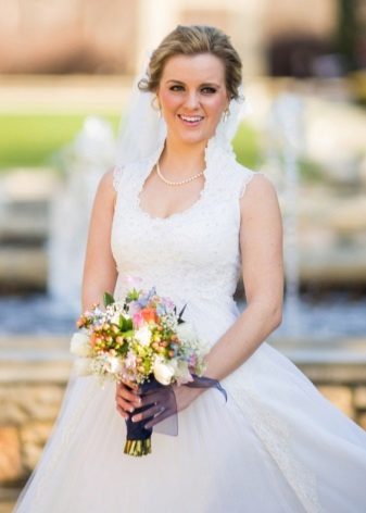 Bridal bouquet to a wedding dress with a high waist