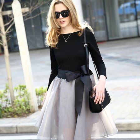 Gray skirt with a bow in combination with a black top